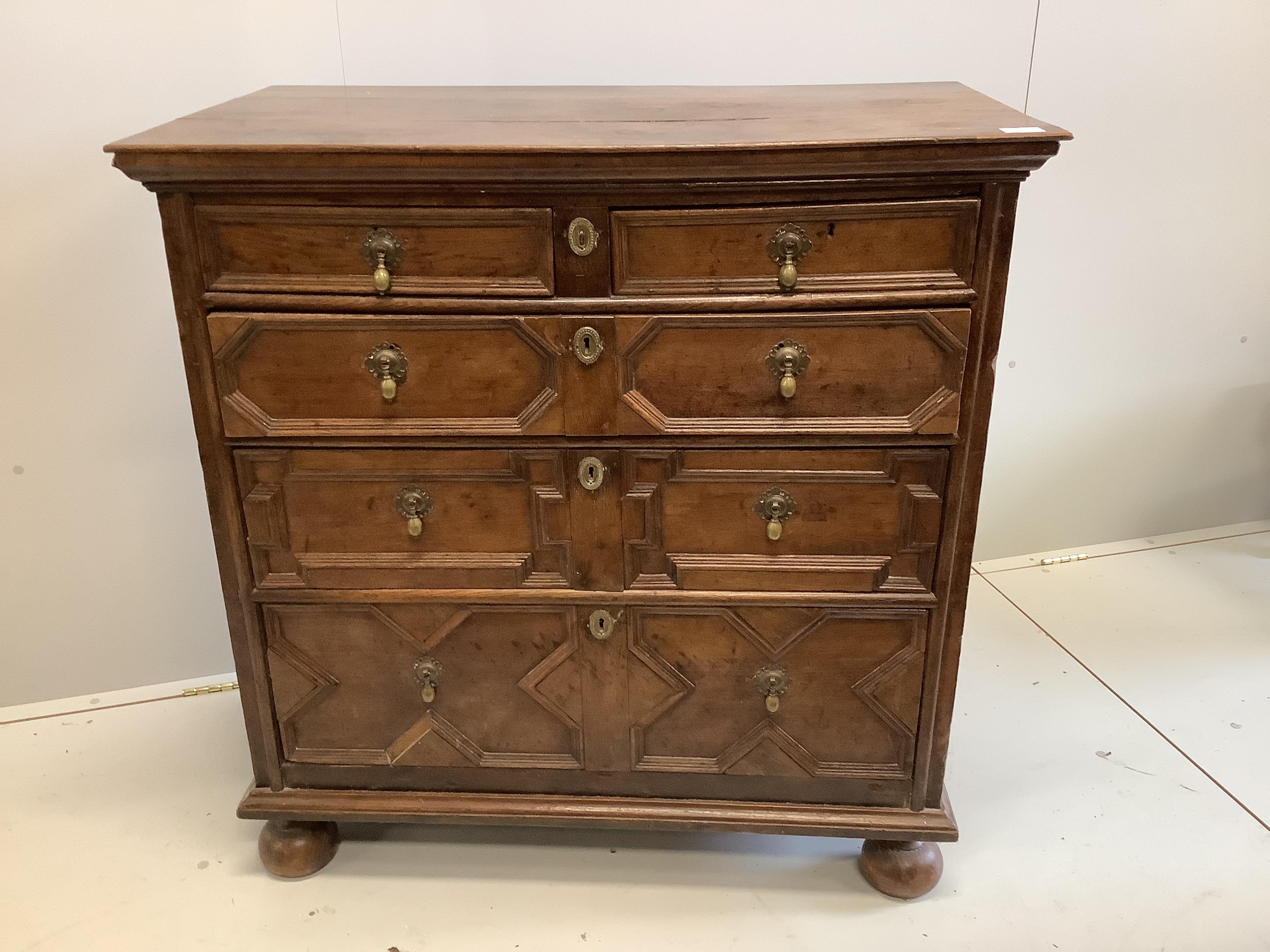 A 17th century and later oak chest of drawers, geometric moulding, raised on bun feet, width 102cm, depth 54cm, height 104cm